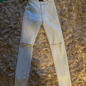 High waisted jeans ripped knees.